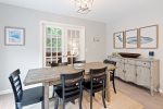 Beautiful coastal decor in the dining area with seating for six